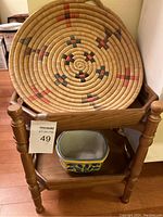 Photo of the small wooden shelf holding a Native American basket and ceramic planter