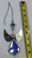 Full view of the new angel hanging crystal suncatcher with chain and ruler for size reference showing about 10 inches in length.