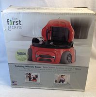 Box front showing the First Years brand and image of the race car potty trainer along with features and age suitability