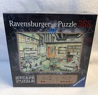 Box of new, sealed Ravensburger Escape Puzzle with an illustrated room on the front cover, 368 pieces.