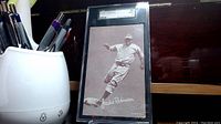 Front of encapsulated card showing full image of Jackie Robinson and slab