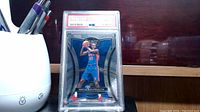 Front image of Sekou Doumbouya rookie card graded 10 by PSA, showing player in blue uniform with basketball