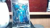 Front side of the sealed trading card showing Alex Bowman in racing suit with his autograph in blue ink.