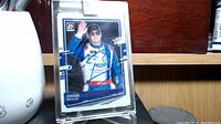 Front of Chase Briscoe signed trading card in sealed plastic case, showing his image and autograph