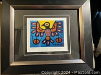 Framed Christian Morrisseau Thunderbird print with colorful Thunderbird image centered in a dark wood frame with glass.