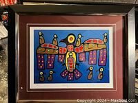 Front view of framed colorful print by Christian Morrisseau featuring stylized birds.