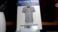 Photo showing front view of Miami Marlins 2017 game worn jersey with team name and number plate, displayed on a show card describing the item.