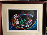 Front view of the framed colorful abstract print titled "Beautiful Warrior" by Don Chase, showing stylized human profile and fish.