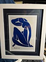 Front view of Henri Matisse Blue Nude II print in white frame with blue and white matting showing the artwork distinctly.