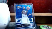 Front view of Kevin Garnett Boston Celtics basketball card with embedded jersey swatch in protective plastic case.