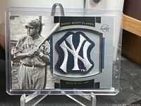 Front of the Babe Ruth card with New York Yankees patch, showing vintage image of Babe Ruth and the embroidered team logo patch.