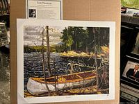 Flat, unframed 24x20 inch print of Tom Thomson's 'The Canoe,' showing a canoe near lakeshore with natural details.