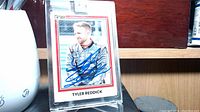 Front of Tyler Reddick signed Nascar card showing autograph and image of driver in racing suit.