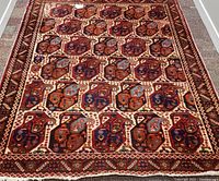 Full view of the Persian Bijar rug laid flat, showing the overall pattern and color scheme.