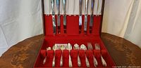 Close view inside box showing arrangement of forks and spoons