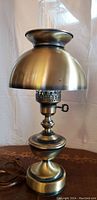 Full view of the antique table lamp showing the brass finish and overall shape.