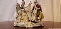 Front view of the Dresden porcelain figurine showing both musicians on an ornate base