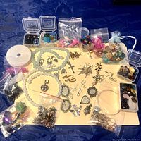 Overview photo of assorted beads, charms, and jewelry making supplies spread on a surface