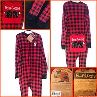 Front and back views of red and black buffalo plaid long johns pajamas hanging on hanger, showing black ribbed sleeve cuffs and back flap pocket with bear illustration and 'Bear Cheeks' text.