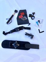 Overview of all GoPro mounts and accessories included in the lot spaced out on white background