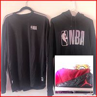 Photo showing two black NBA shirts hanging on hangers: one crewneck long-sleeve with striped sleeve design and small NBA logo, and one hoodie with large NBA logo on front. Overlay inset showing red and black Air Jordan duffel bag with Jumpman logo.