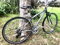 Full side view of the Trek 7100 Multitrack hybrid bike showing frame, wheels, drivetrain, brakes, and suspension.