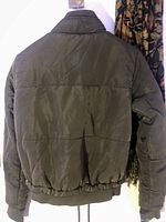 Back view of the olive green quilted jacket showing elastic waist and cuffs