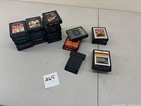 Stack of Atari 2600 cartridges showing game labels such as Combat, Night Driver, Pitfall!, Robot Tank, Laser Blast