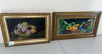 Two floral artworks side by side: a painting with dark background and soft pastel flowers, and a colorful floral print with bright flowers.