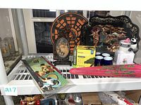 Lot of Japanese decorative items including wooden tray with figure art, paper dart board with dragon, bonsai starter kit, carved wooden dragon figurine, tea cups, panda figurine and cup.
