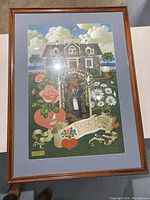 Overall framed print showing the entire artwork with house, garden, couple, and floral elements.
