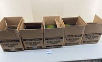 Five open Kenner/Hasbro Star Wars figure assortment boxes lined up side by side on a table, each containing multiple blister-carded figures.