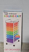 Front box image showing the brand-neutral 10-drawer rolling cart with rainbow-colored drawers and chrome frame.