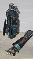 Photo showing two golf bags with golf clubs; one standing upright, one lying down