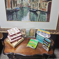 Photo of various soaps, massage brush, lotions, detergent, and insect trap on wooden table.
