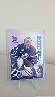 Front of Curtis Joseph hockey card showing him in goalie gear with holographic name text and team logo.