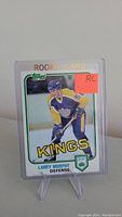 Front of Larry Murphy rookie hockey card in Kings uniform with Topps logo and rookie card designation.