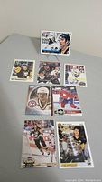 Seven Mario Lemieux hockey cards laid out on table showing various images and series branding