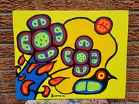 Full front view of the stretched canvas painting against a brick background