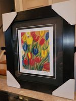 Framed full view of the Maud Lewis "Tulips" print with black frame and corner protectors