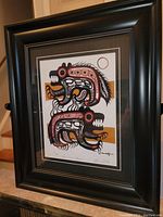 Front view of the professionally framed fine art print by Tim Tait showing the full artwork in black, red, white, and ochre colors with detailed indigenous Woodland style patterns.