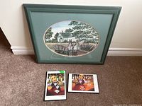 Photo of the limited edition framed print leaning against wall with two small plaques placed in front of it on carpeted floor.