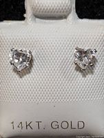 Close-up front view of the pair of heart-shaped cubic zirconia earrings set in 14K gold showing the stones and part of the earring post.