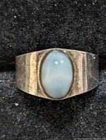 Top view showing the oval Larimar stone set in a silver band.