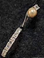 Close-up of ring with pearl and clear stones