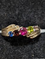 Close-up front view of the sterling silver mixed gemstone ring showing five colorful stones.