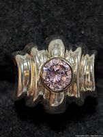 Close-up of the sterling silver amethyst ring showing ribbed band and bezel-set round amethyst stone.