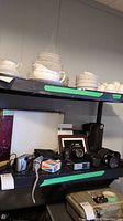 Shelf displaying Canon T90 SLR camera body, three lenses, Sony and Fujifilm cameras, camera bags and cases, and boxed items.