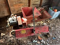 Photo of the red MTD Shred-It gas chipper with hopper and engine, showing overall lot items and condition.