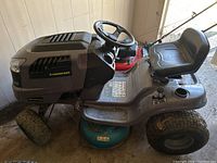 Side view of full mower showing body, deck and tires